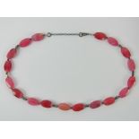 An 'as new' hot pink hardstone necklace having 925 silver clasp, in box.