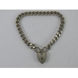 A HM silver heavy curb link bracelet having heart padlock clasp,