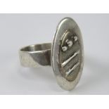 A white metal abstract design ring, no apparent hallmarks, size T-U.