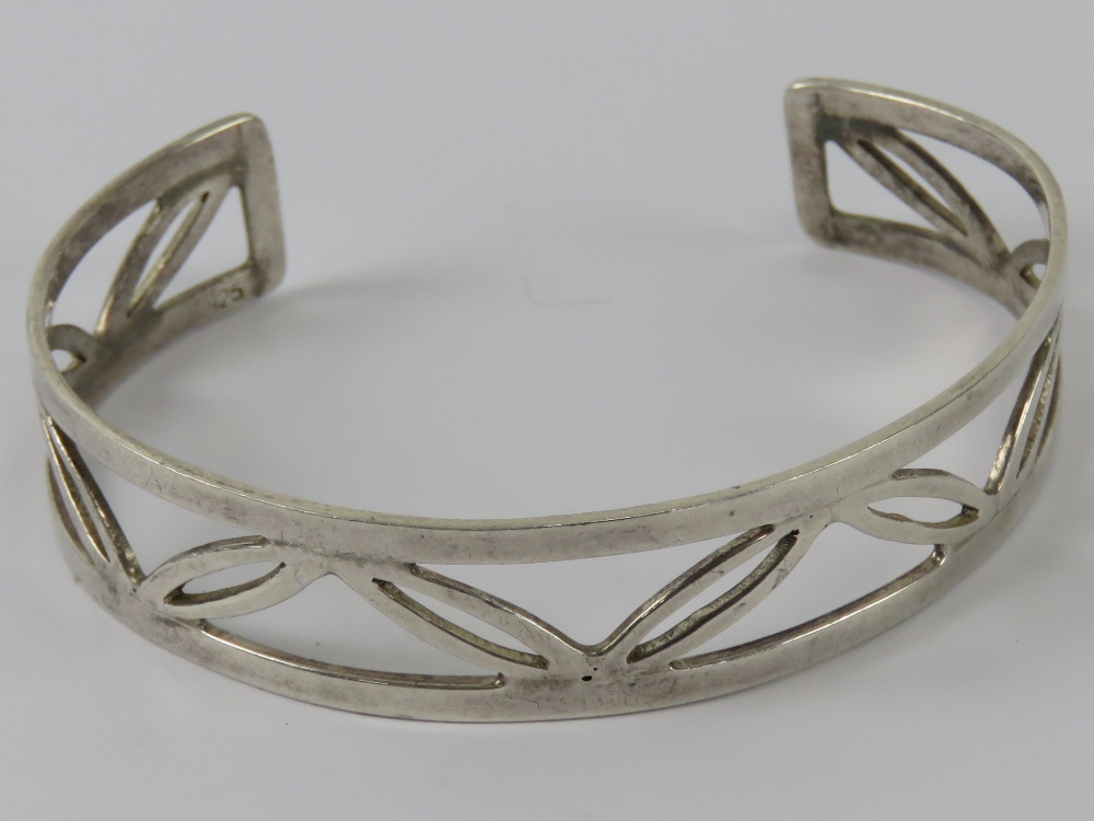 A HM silver bangle having open leaf pattern, 15mm wide, hallmarked 925 and further stamped 925.