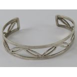 A HM silver bangle having open leaf pattern, 15mm wide, hallmarked 925 and further stamped 925.