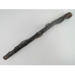 An Irish black painted natural wood Shillelagh. 58cm in length.