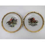 A pair of hunting themed decorative plates featuring huntsman on horseback with hounds at feet,