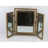 A gold painted tryptic dressing table mirror standing 50.5cm high approx 63cm wide standing.