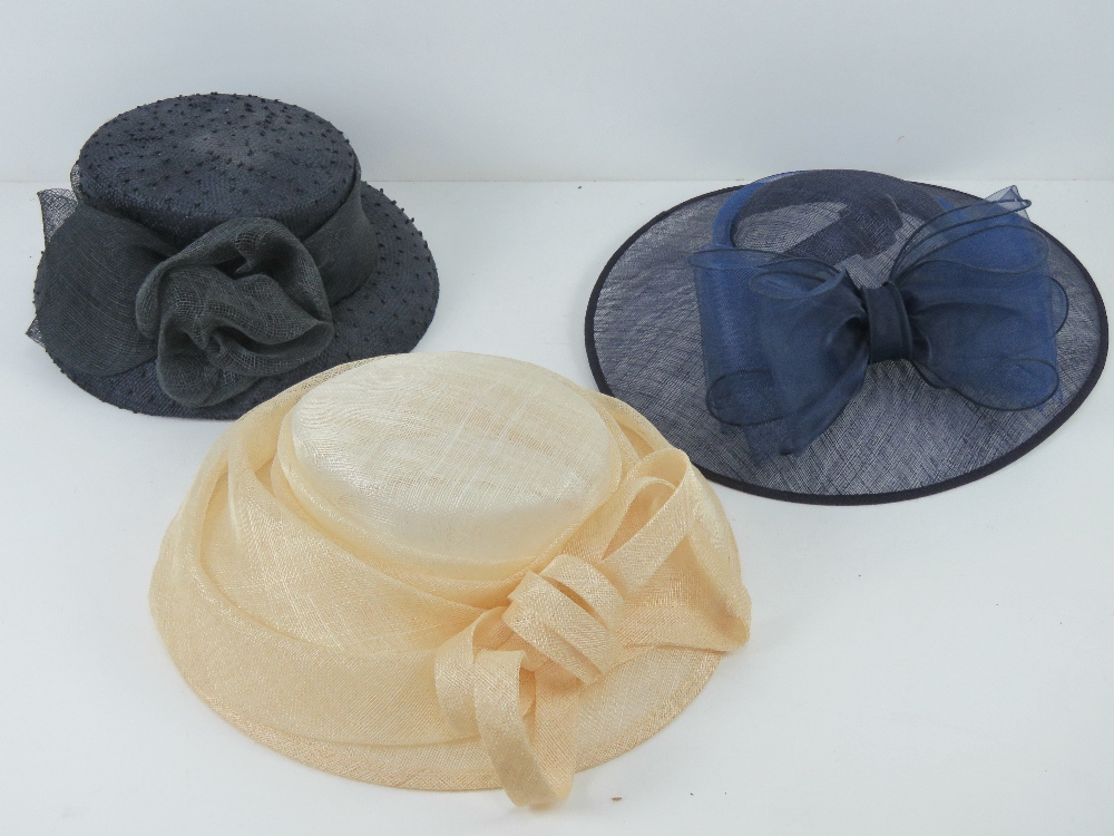 Three ladies hats being blue, cream and