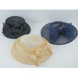 Three ladies hats being blue, cream and