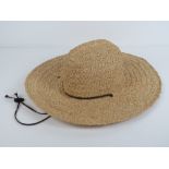 A handmade raffia straw hat made by Scal
