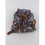 A navy and pink butterfly themed rucksac