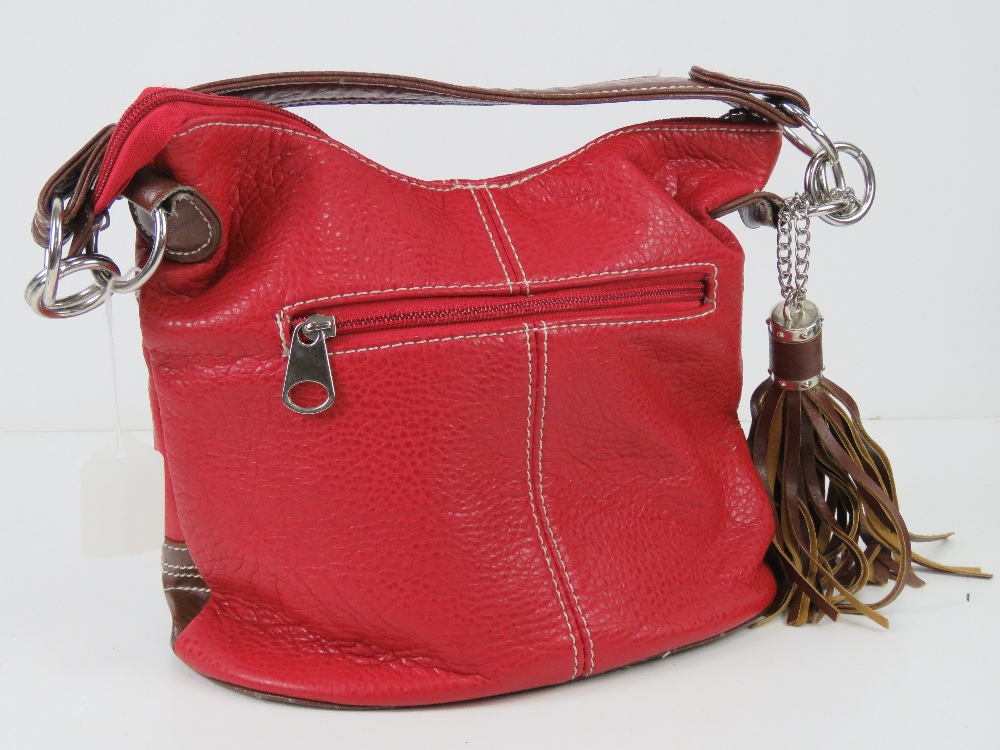 A red and brown Paula Rossi handbag with