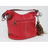 A red and brown Paula Rossi handbag with