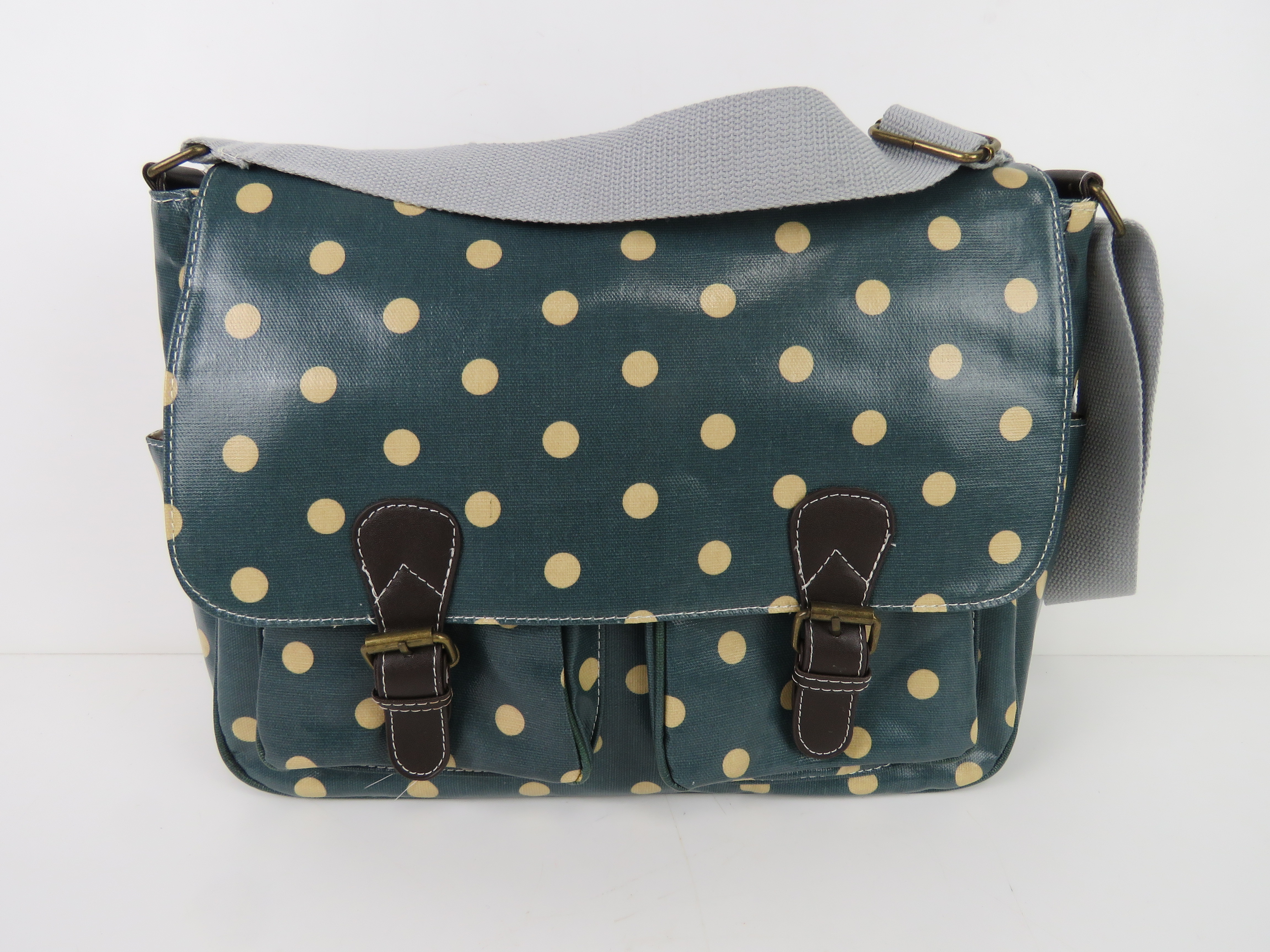 A green polka dot satchel type handbag '