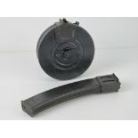 A PPSH-41 drum magazine together with a