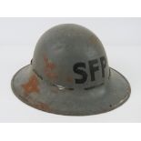 A WWII British SFP helmet with liner and chin strap, dated 1941.