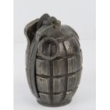 A WWII British Mills grenade with spoon and pin, bearing TA S markings upon.