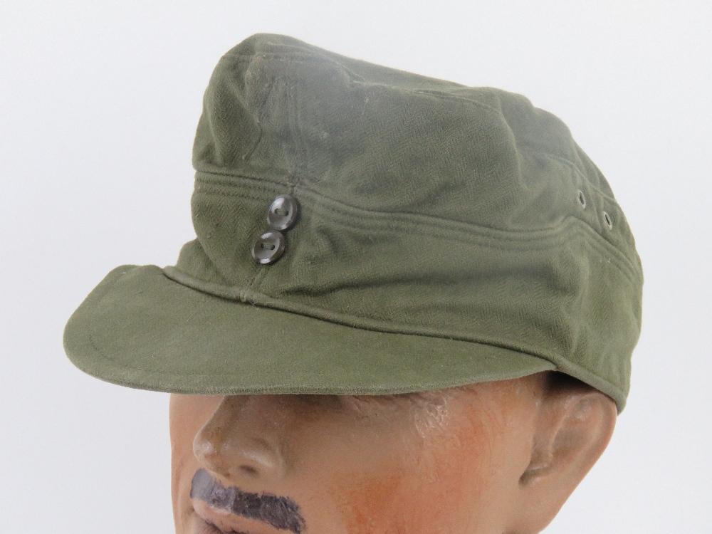 A green cloth 'tropical' cap having removed label and removed cloth badge from front.