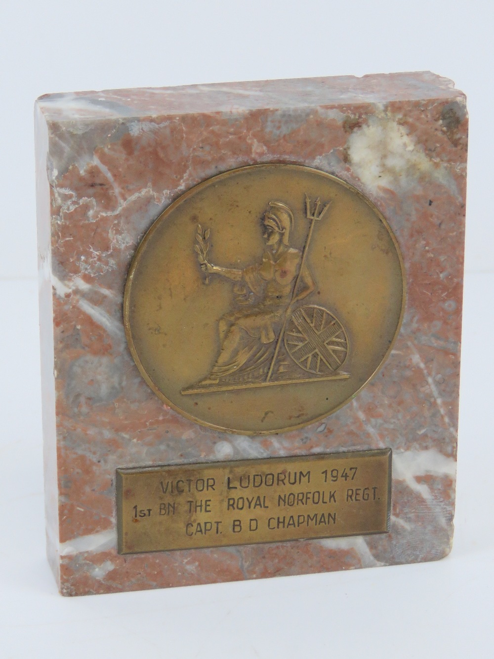 A marble base award dedicated to Capt. B D Chapman in the 1st BN The Royal Norfolk Regt in 1947.