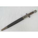 A Lee Enfield bayonet with scabbard, dated 1894 with WD markings and serial number 745 upon.