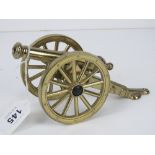 A British made brass model of a cannon having GR upon, approx 18cm in length.