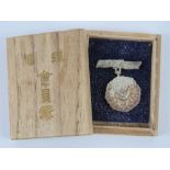 A WWII Japanese Mount Fuji medal in box.