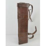 A WWII leather tripod case with carry strap.