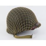 A WWII US Army McCord helmet having heat stamp that dates it to 1945,