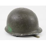 A WWII US helmet having liner and chin strap.
