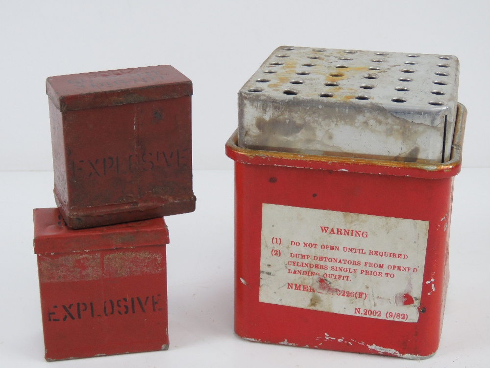 An empty British Mills detonator box with two empty fuse pots.