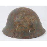 A WWII Japanese helmet with liner.