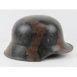 A reproduction WWI German M16 camo helmet with liner.
