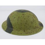 A WWII British helmet, having chin strap hooks either side, strap deficient.