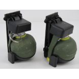 Two inert dummy grenades with grenade holders.