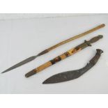 A Kukri with wooden handle together with an Oriental style dagger and an African short spear.