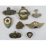 A WWII Rhodesia Air Force brass cap badge together with other military badges and an enamelled