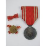 A WWII Japanese Red Cross Medal and lapel badge in box.