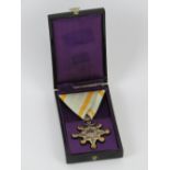 A WWII Japanese Order of the Sacred Star 8th Class medal in box.