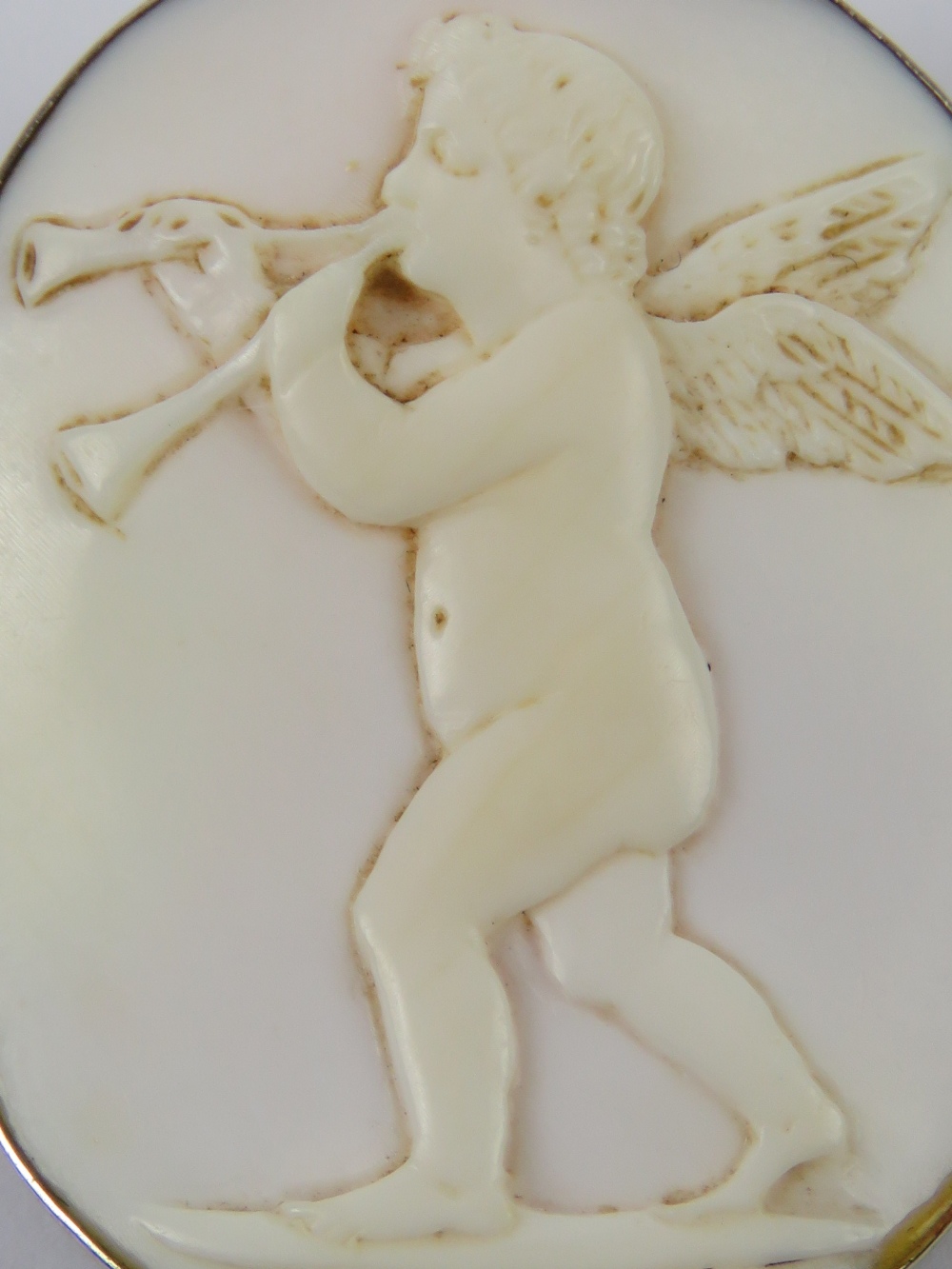An 'angel skin' coral carved cameo in the form of a cherub playing a musical instrument, - Image 3 of 3
