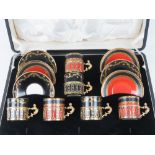 A set of six Royal Worcester coffee cans in HM silver holders in original box with saucers.