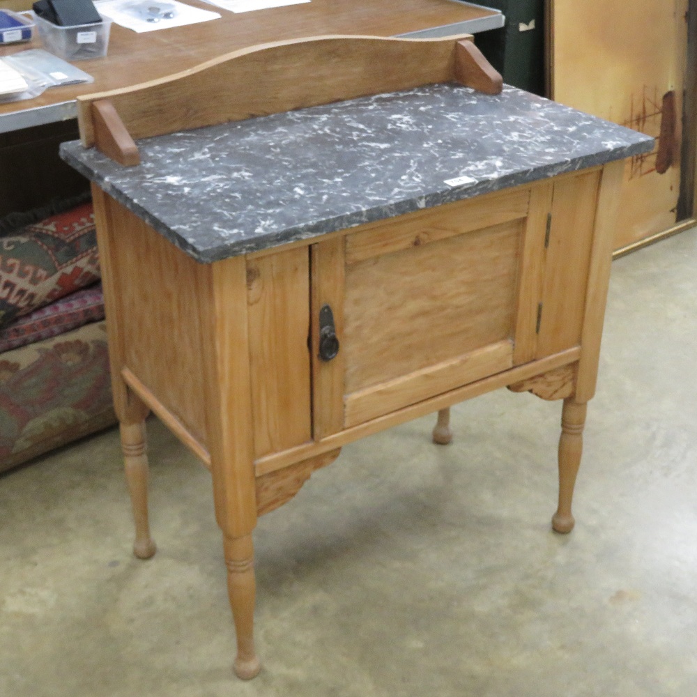 A pine washstand having composite marble top with single door under, 76 x 46 x 86cm.