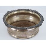 A silver plated wine coaster having turned wooden base with green baize upon, 17cm dia, 12.