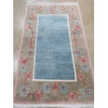 A good woollen and silk floral design rug with central blue panel measuring 166 x 101cm.