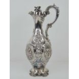 An impressive HM silver Victorian lidded carafe having acanthus leaf and foliate decoration