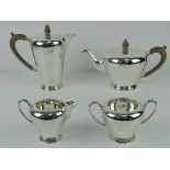 An Art Deco HM silver four piece tea service comprising teapot and coffee pot with wooden handles