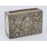An HM silver matchbox cover having repousse floral design to front, measuring 7.6 x 5.2 x 2.