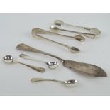 Two pairs of HM silver sugar tongs together with a pair of HM silver salt spoons,