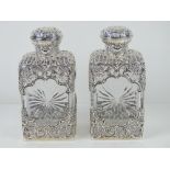 A delightful pair of William Comyns HM silver overlaid spirit decanters,