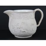 A cream ground pottery decorative jug having Classical scenes upon, impressed mark Turner to base,