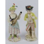 A pair of Continental Musician figurines, each bearing 'N' with crown over to base, 16cm high.
