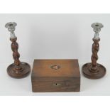 A pair of barley twist oak candlesticks with plated sconces, each measuring 25cm high,