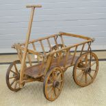 A Victorian style ash framed four wheeled dog cart with turn table front axle and hand drawbar.