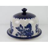 A blue and white ironstone cheese plate and cloche.